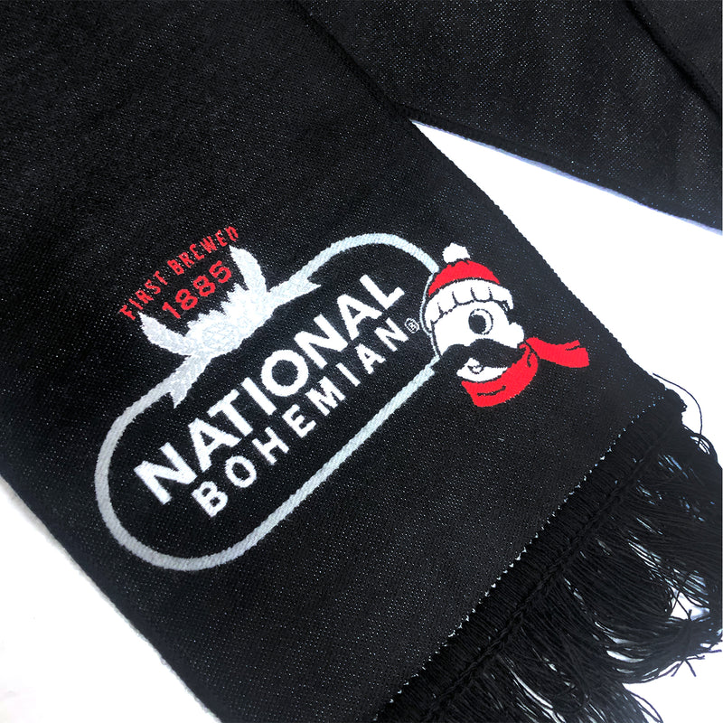 close up of black and silver logo with Mr. Boh wearing scarf and beanie